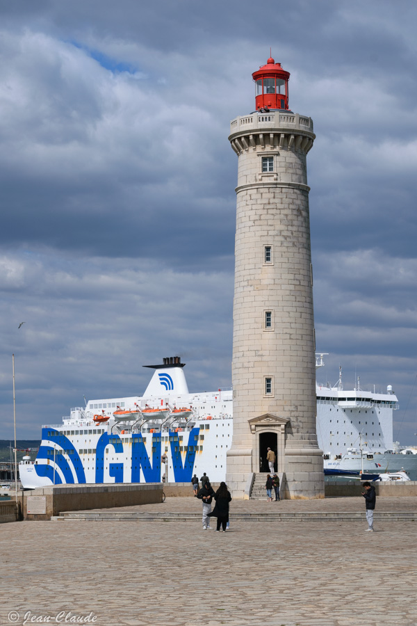 Le phare Saint-Louis à Sète avec en arrière plan un bateau de croisière amarré au port.